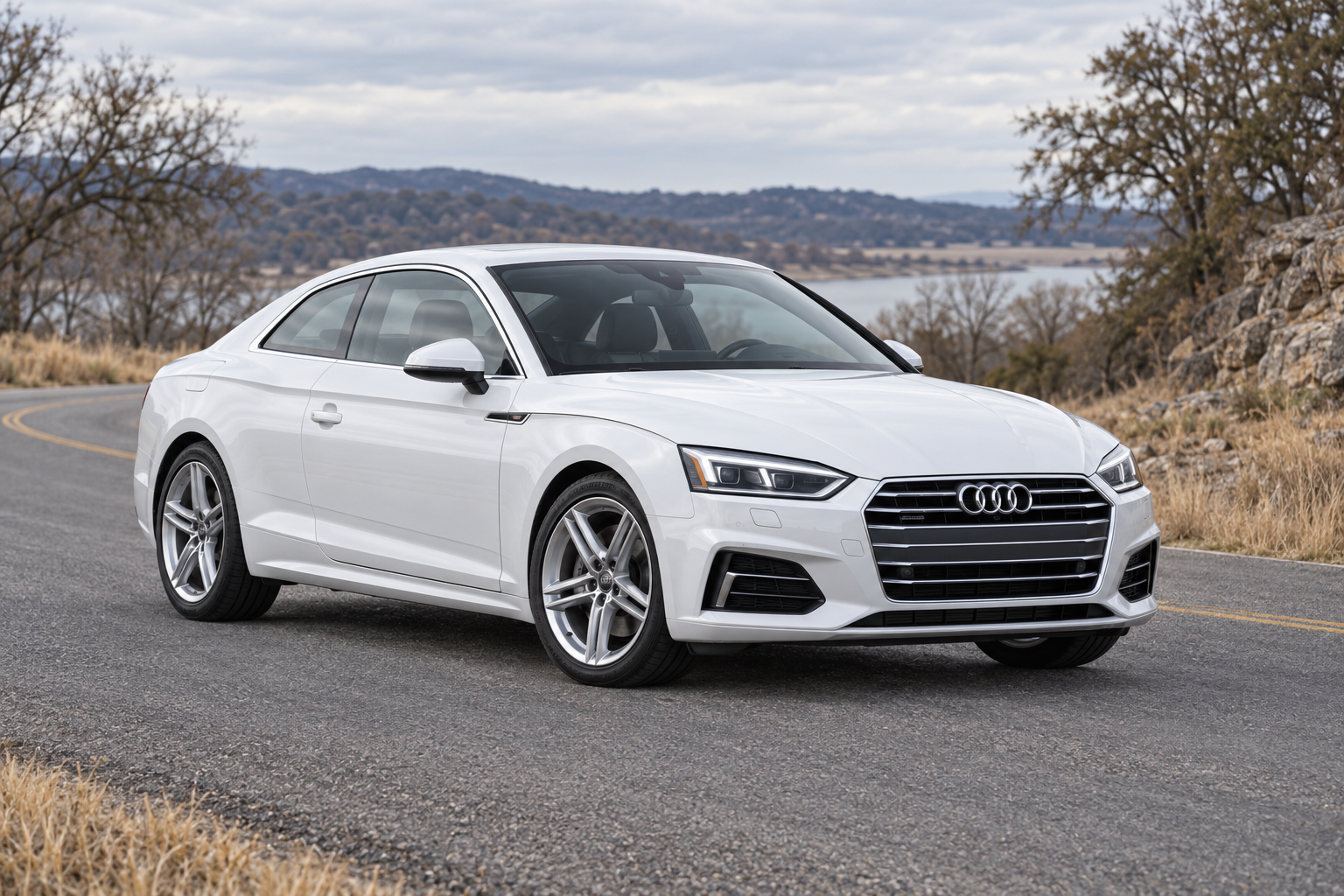 Illustrative white Audi A5 F5 coupe on a quiet paved road