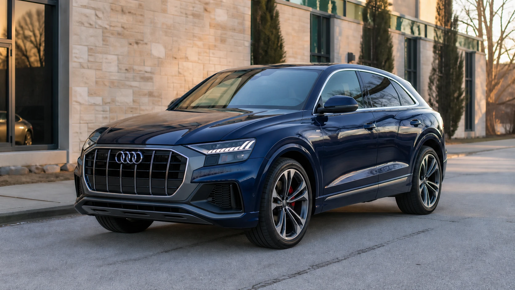 Blue Audi SQ8 outside a limestone commercial building for Cedar Performance tuning