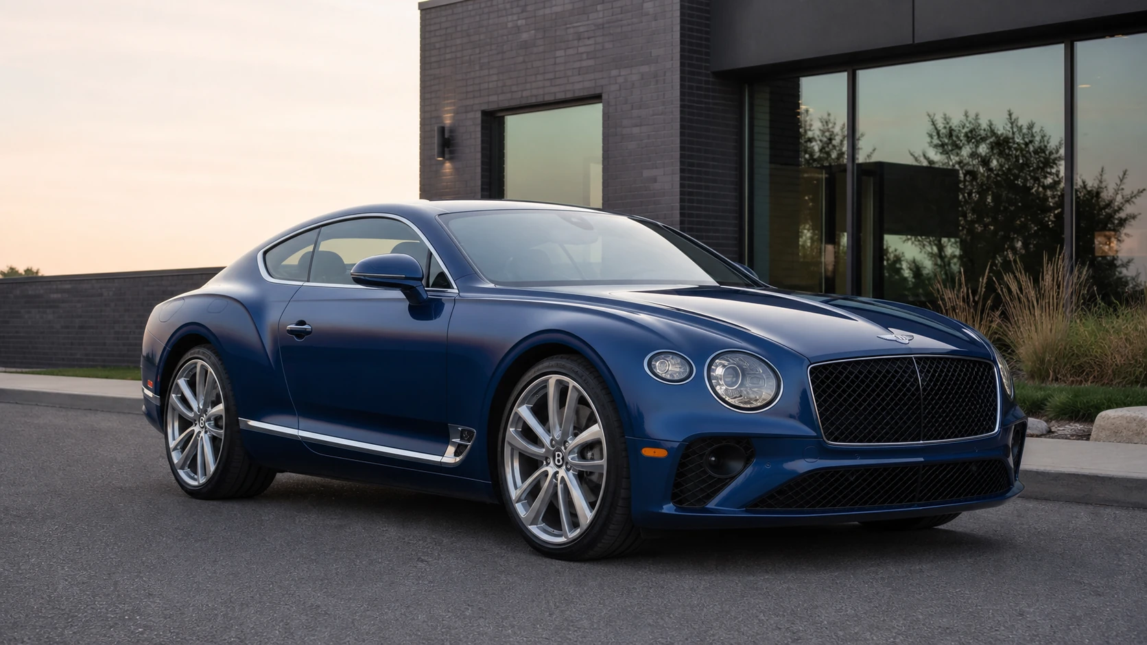 Blue third-generation Bentley Continental GT outside a modern brick building