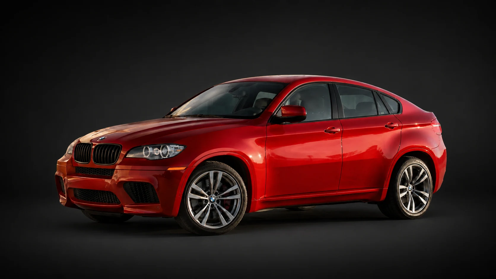 Red E71 BMW X6 M on a deliberate dark non-location catalog background