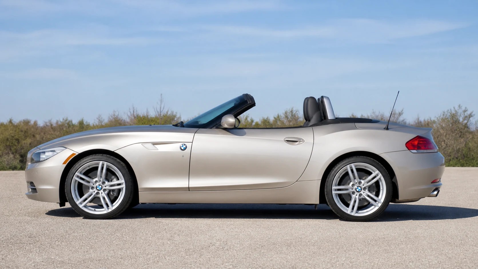 Champagne-silver E89 BMW Z4 with the roof open in full side profile