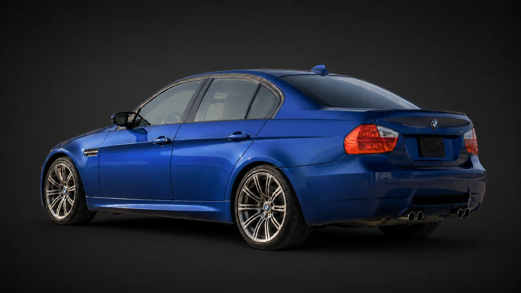 Blue E9x BMW M3 on a deliberate dark non-location catalog background