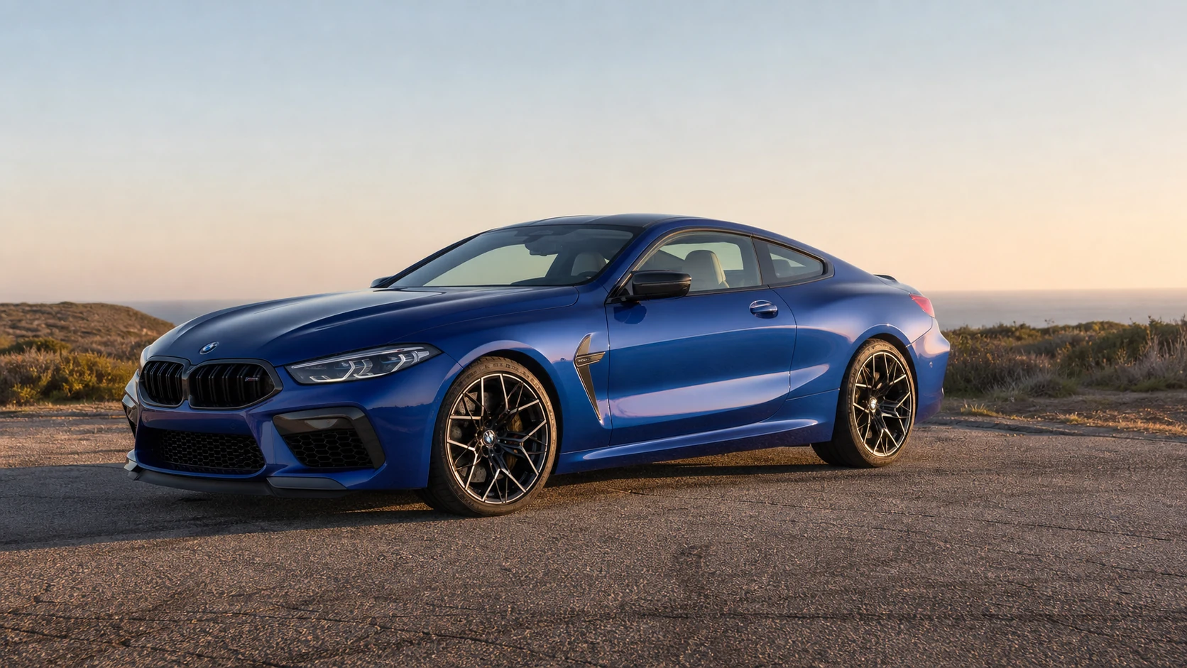 Blue F92 BMW M8 coupe at a weathered coastal turnout
