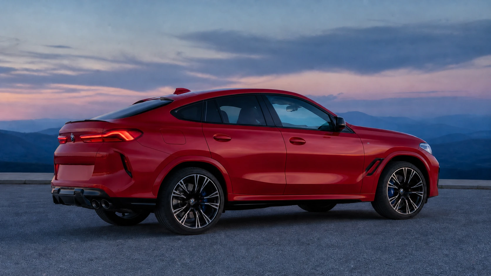 Red F96 BMW X6 M coupe SUV in a rear-side profile above distant hills