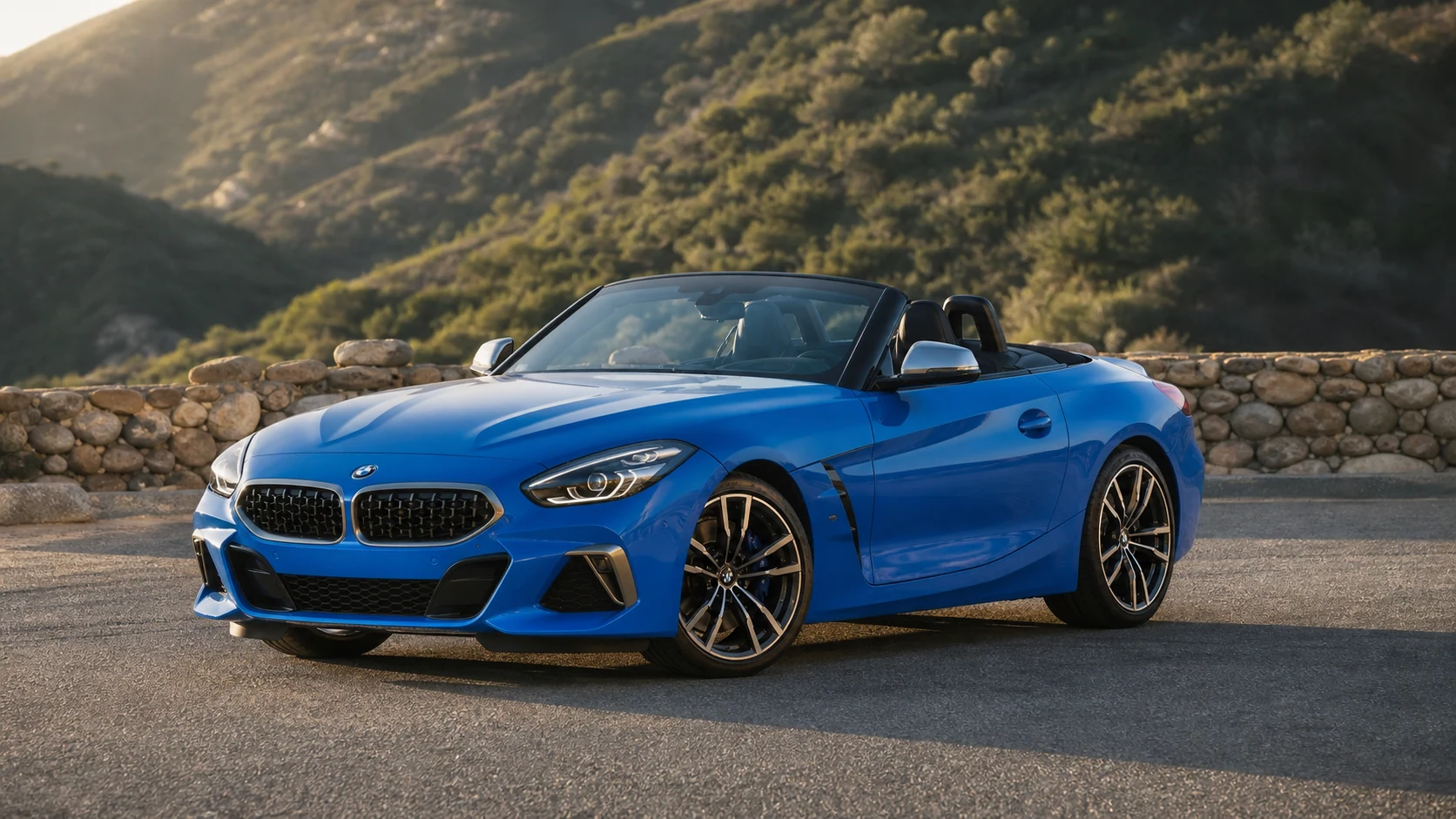 Blue G29 BMW Z4 with the roof open beside a stone wall and low hills