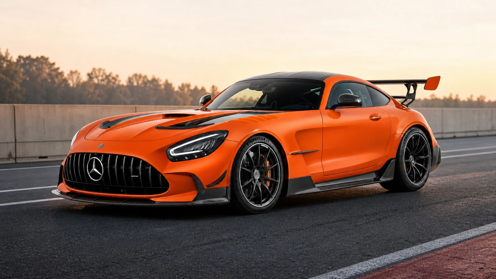 Orange Mercedes-AMG GT Black Series photographed in an unbranded circuit paddock