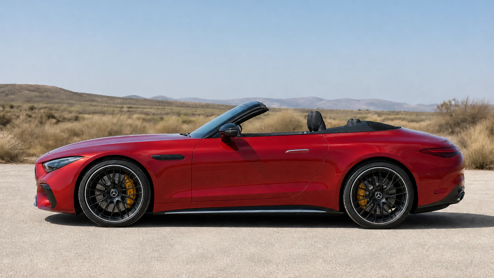 Red R232 Mercedes-AMG SL roadster in full side profile against open scrub terrain