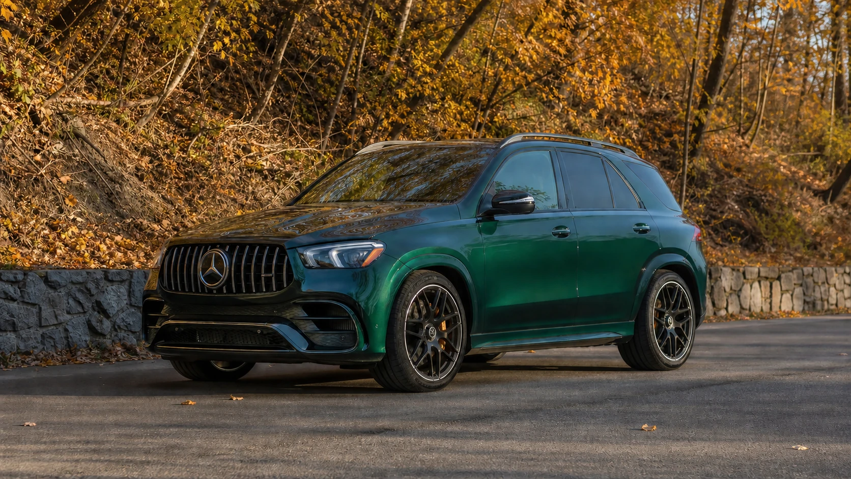Green V167 Mercedes-AMG GLE63 beside an autumn woodland road