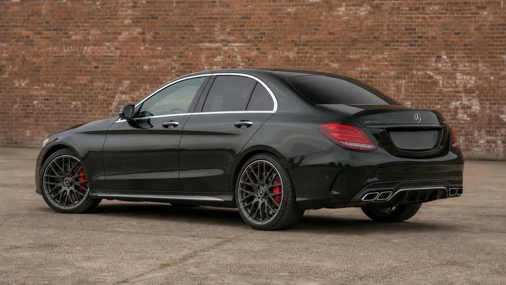 Dark W205 Mercedes-AMG C63 sedan in a rear three-quarter view beside an aged brick wall