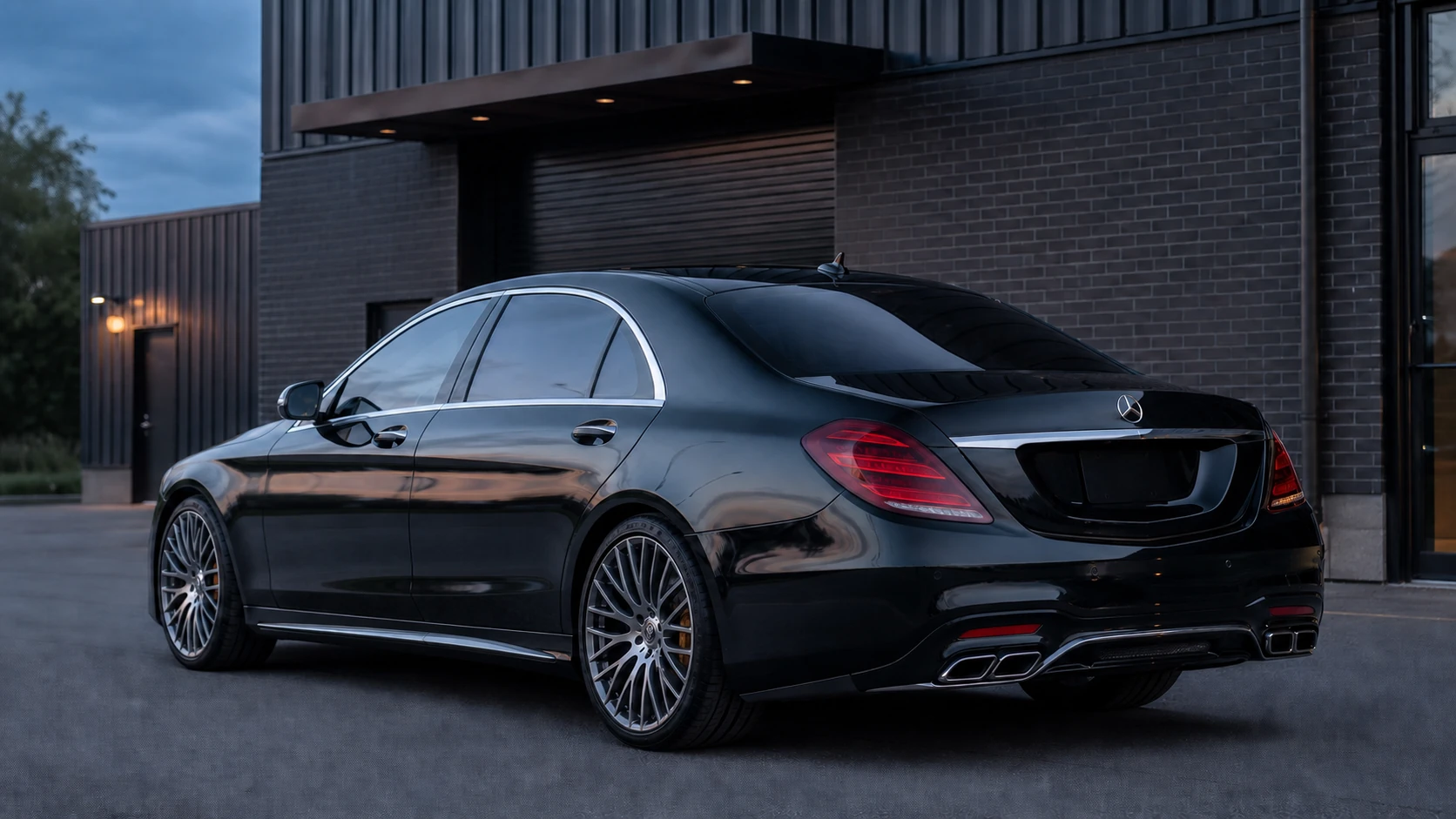 Black W222 Mercedes-AMG S63 outside a dark brick performance facility