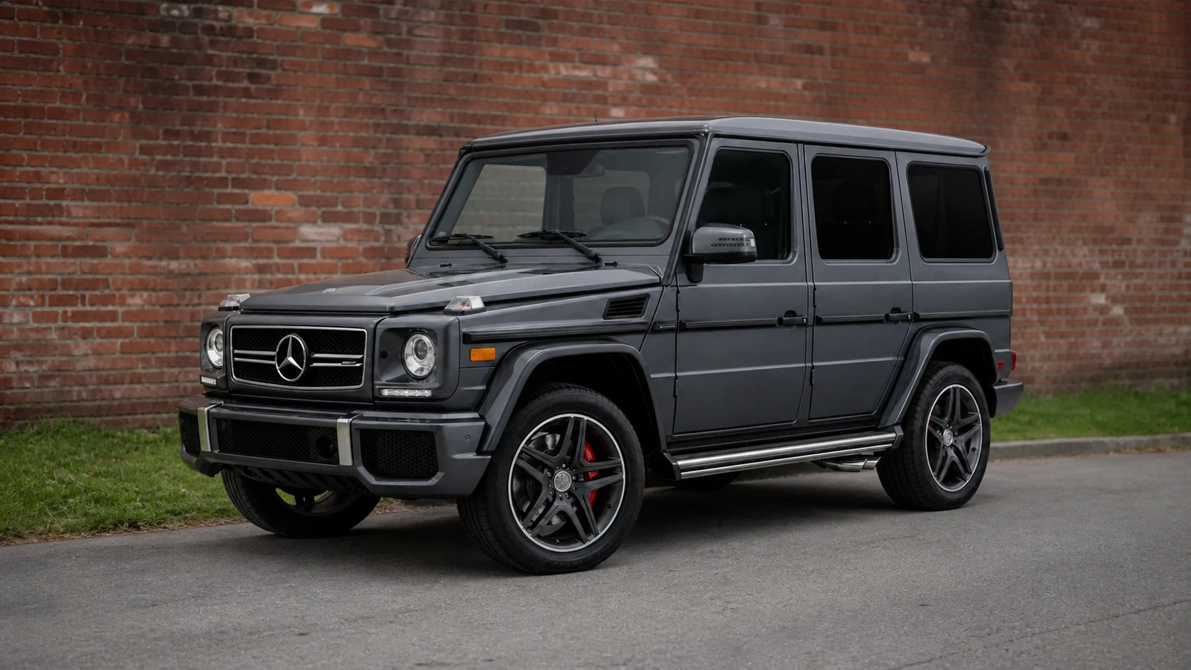 Gray pre-2019 W463 Mercedes-AMG G63 beside an aged brick wall