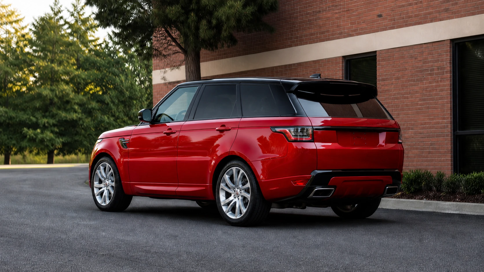 Red facelift L494 Range Rover Sport outside a brick commercial building