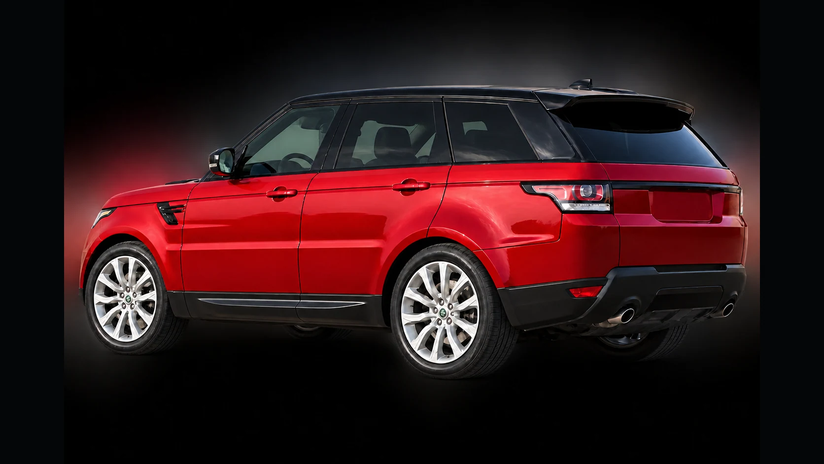 Red pre-facelift L494 Range Rover Sport on a deliberate dark non-location catalog background