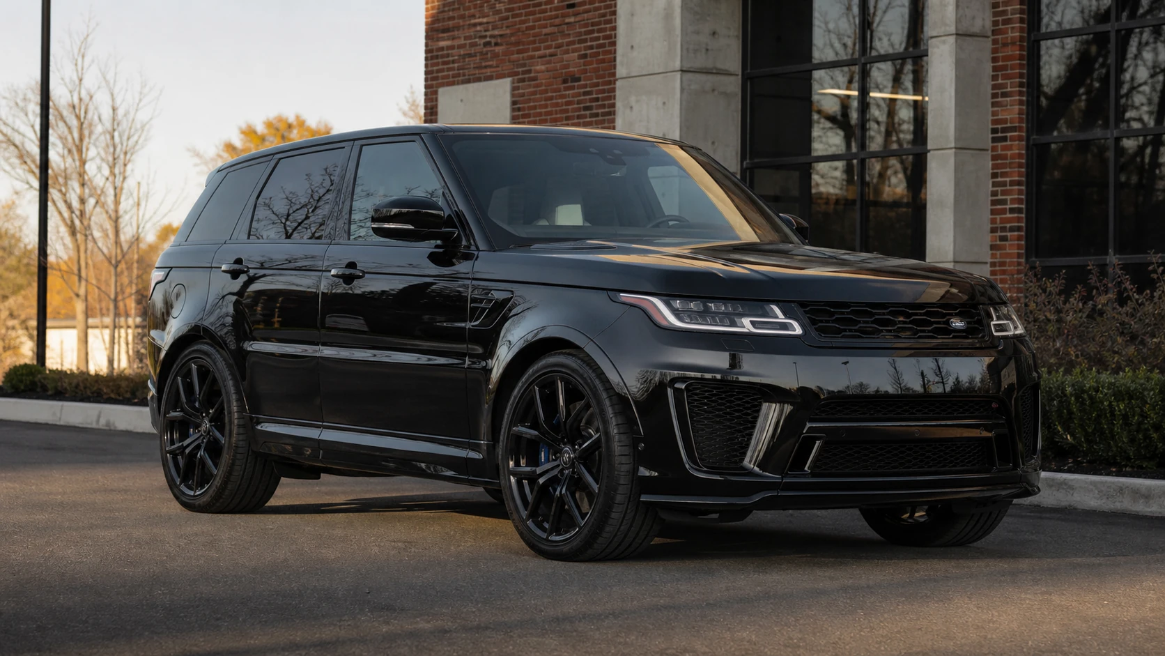Black facelift L494 Range Rover Sport SVR outside a brick performance building